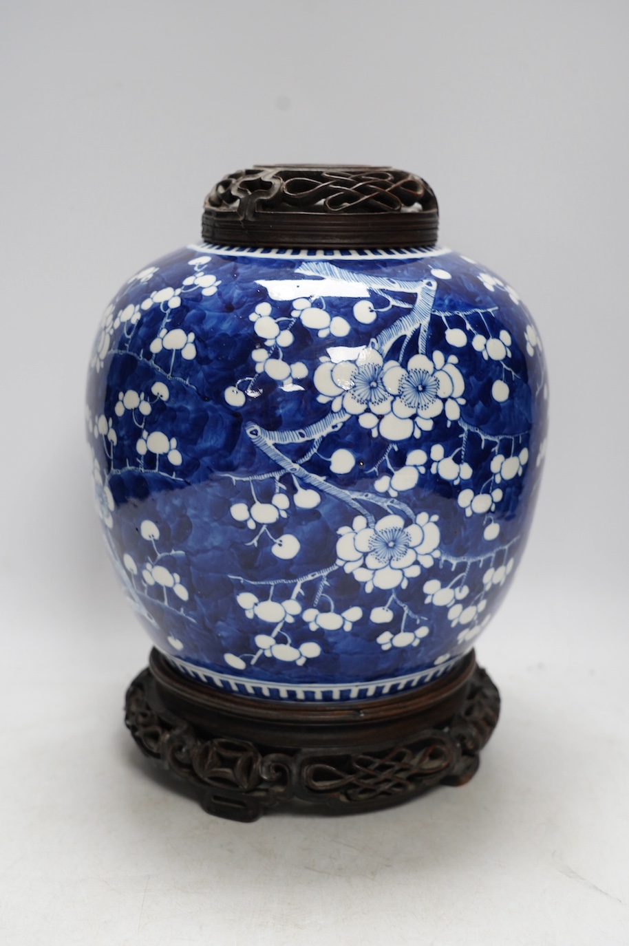 A 19th century Chinese blue and white ginger jar with hardwood stand and cover, overall 30cm high. Condition - jar and stand good, cover repaired